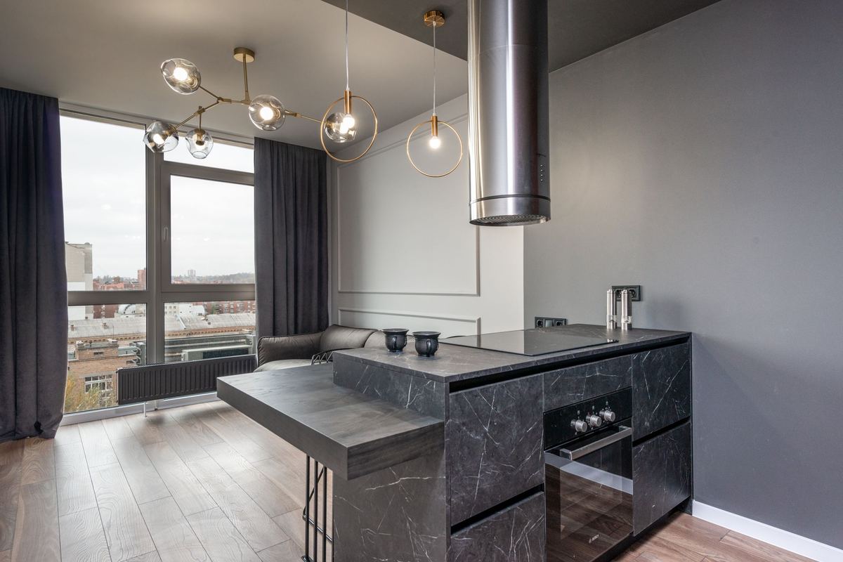 Apartment kitchen island beside a window looking over the city