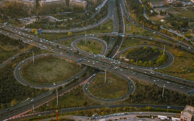 Aerial view of a cloverleaf freeway interchange and its looping ramps