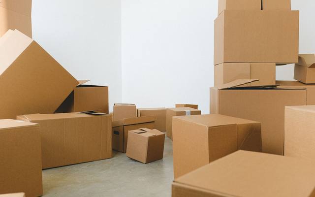 Cardboard moving boxes stacked in an empty room