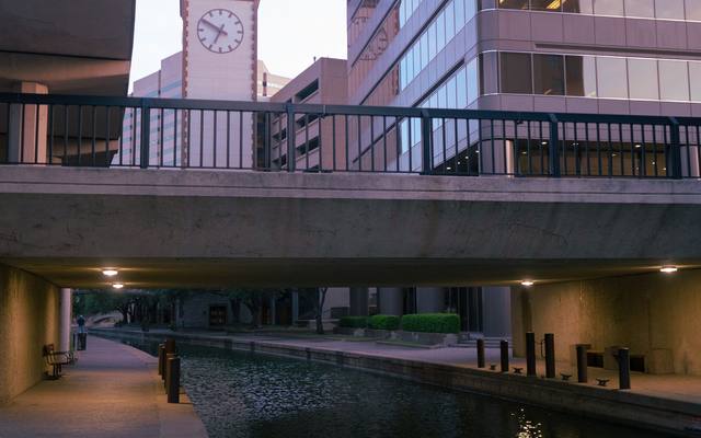 Walkway and canal passing beneath a bridge on the San Antonio River