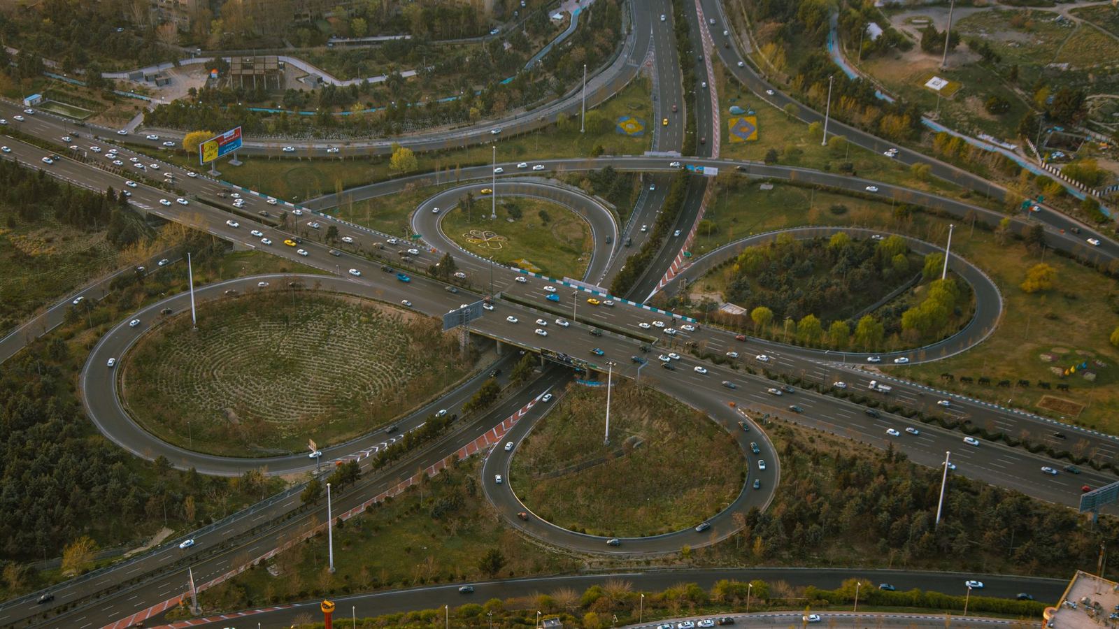 Aerial view of a cloverleaf freeway interchange and its looping ramps