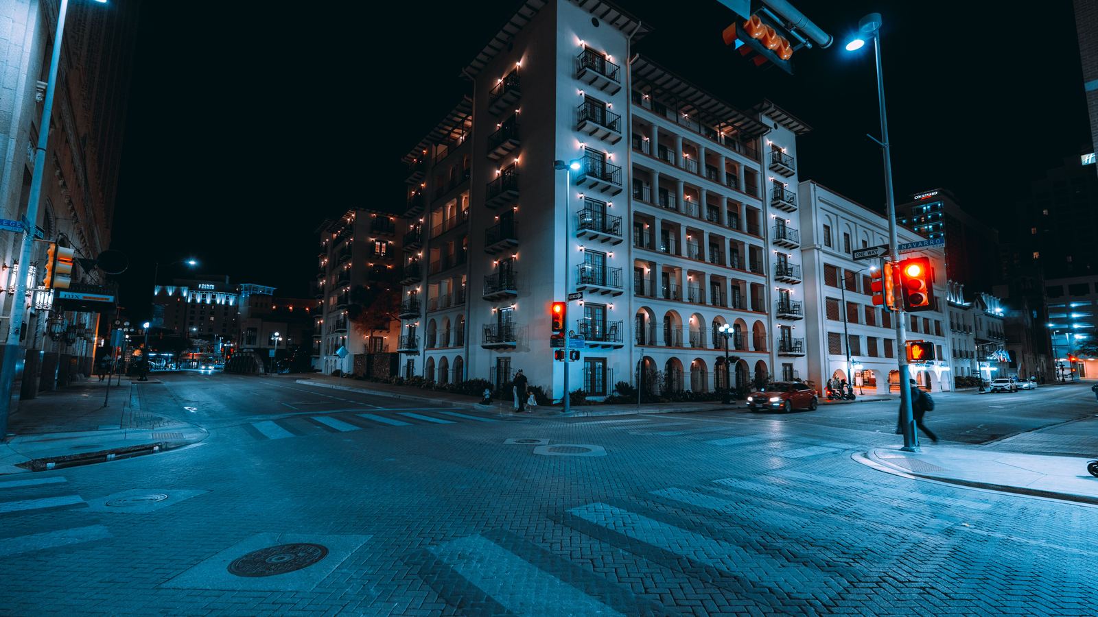 Quiet downtown San Antonio street crossing lit at night