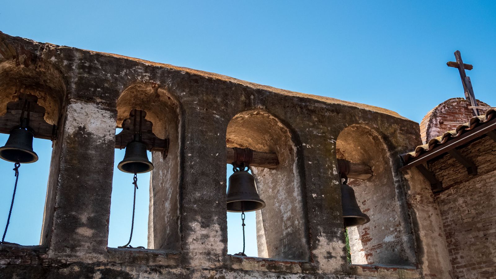 Bells hanging in the stone arches of a San Antonio mission