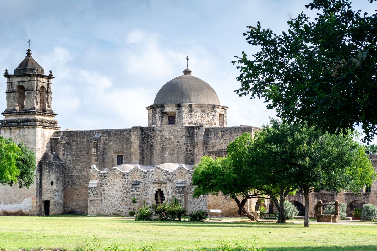Mission San Jose and its walled grounds on a clear day in San Antonio