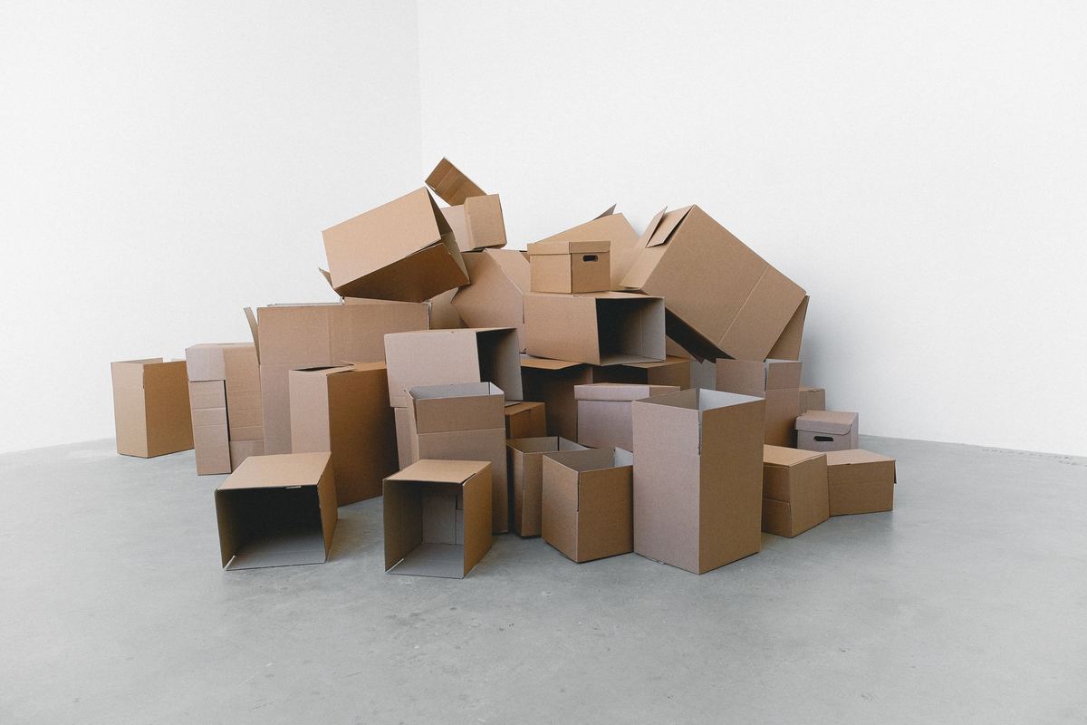 A loose pile of flat and open cardboard moving boxes