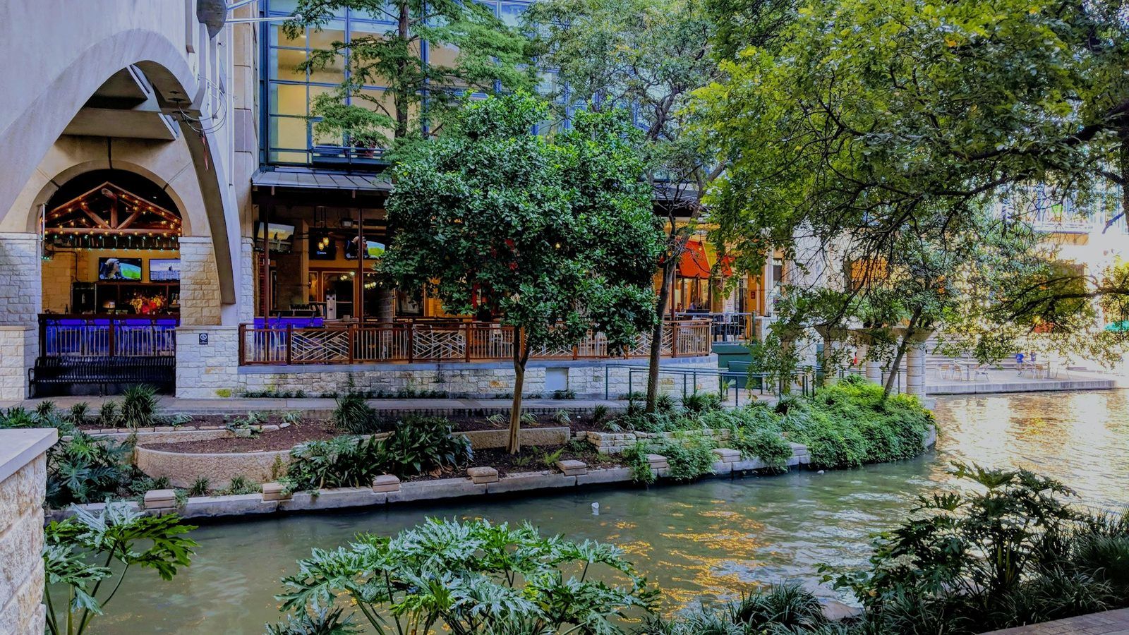 Daytime terraces, greenery and still water along the San Antonio River Walk